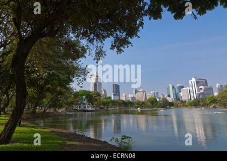 Horizontal panoramic view towards the Silom-Sathorn CBD (central Business district) across the lake at Lumphini park in Bangkok. Stock Photo