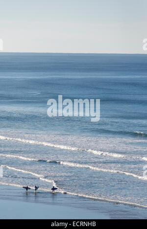 Surfers heading out from Agate Beach on the Oregon Coast. Stock Photo