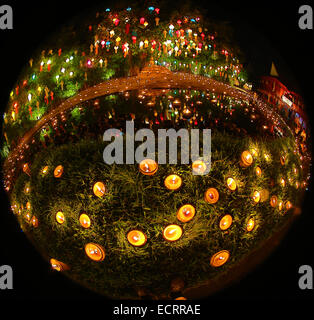 Lanterns and candles reflected in a pool with a Buddha stature for the Loy Krathong Festival at Wat Phan Tao Temple in Chiang Ma Stock Photo