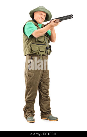 Full length portrait of a mature hunter aiming with a shotgun isolated on white background Stock Photo