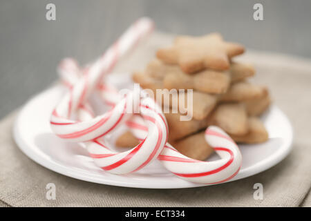 holiday cookies and candy canes on wood table,  rustic photo Stock Photo