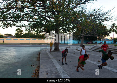 Havana, Cuba. 18th Dec, 2014. Children wearing leisure shoes practice sprint running on the non-sport purpose concrete ground, in Havana, Cuba, on Dec. 18, 2014. After the declaration of restoring diplomatic relations between Cuba and the U.S. from both presidents, local Cubans demand the abortion of blockage from Washington. © Liu Bin/Xinhua/Alamy Live News Stock Photo