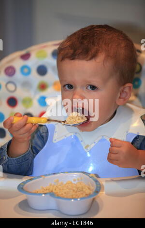 2 years old boy eating pasta. Stock Photo