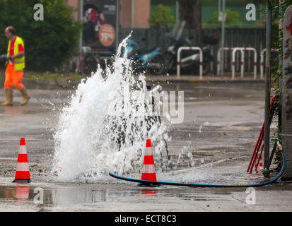 road spurt water beside traffic cones Stock Photo