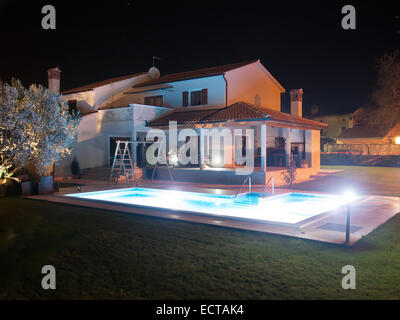 swimming pool and house at night, under lights Stock Photo
