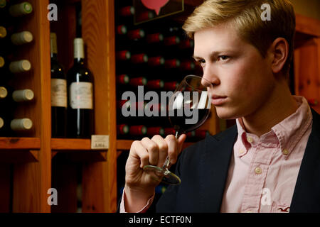 Wine Waiter tasting wine in a cellar Stock Photo