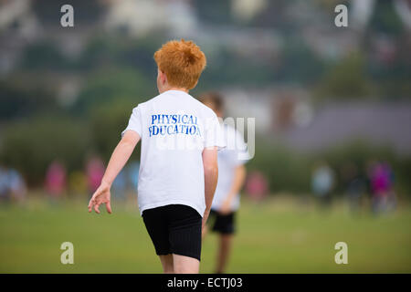 Secondary school PE - physical education Wales UK: games lesson - young teenage boys playing rugby rugger outdoors on a sports field pitch ground Stock Photo