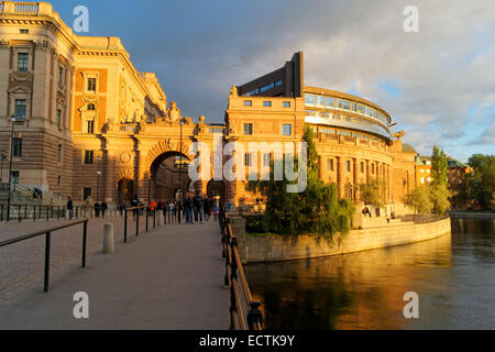 Sveriges riksdag (Parliament House) in Gamla Stan, the old town of Stockholm, Sweden, viewed with evening sun and a dark sky Stock Photo