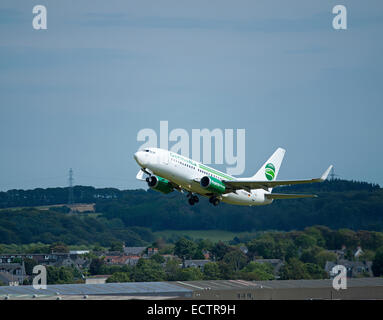 A Boeing 737 flight of Germainia Airlines leaving at Aberdeen from its journey across to Europe.  SCO 9370. Stock Photo