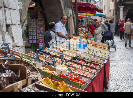 Local lifestyle: Fruit, vegetable and produce stalls and stallholders at the popular local outdoor food market in the old town, Annecy, France Stock Photo