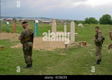 Members of the militia of Chechen leader Ramzan Kadyrov, the later president, near the grave of assassinated president Akhmat Kadyrov in the village of Tsentoroi, Chechnya, Russia. Stock Photo