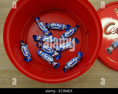 The last unpopular office chocolates, the leftovers from a Mars celebrations red plastic tub at Christmas - Milky Way Stock Photo