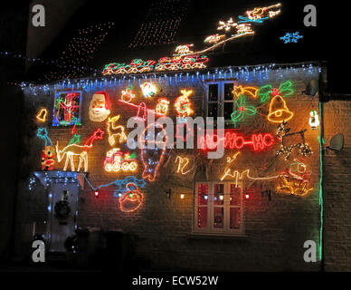 Christmas lights being overdone on a British house - Festive celebrations in December for Xmas Stock Photo