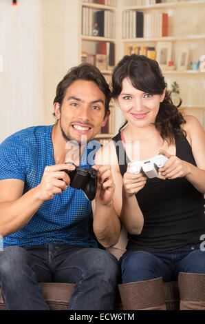 young cute couple playing video games Stock Photo