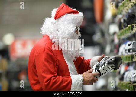 Aberystwyth, Wales, UK. 20th Dec, 2014. 'Santa Claus' is caught shopping for some last minute bargains in a branch of SportsDirect in Aberystwyth on 'Panic Saturday',  the last Saturday before christmas. Credit:  keith morris/Alamy Live News Stock Photo