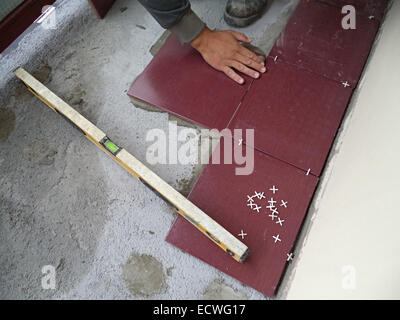 Level red tiles on a floor Stock Photo