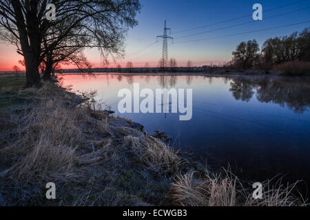 Landscape with Power Line on sunset, sunrise Stock Photo