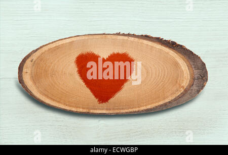 wooden plate with painted heart on a white wooden background Stock Photo
