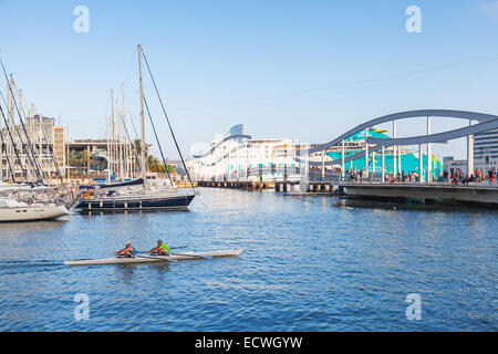 Barcelona, Spain - August 26, 2014: Twin racing rowing boat goes in Vista port harbor with walkway Bridge on a background Stock Photo