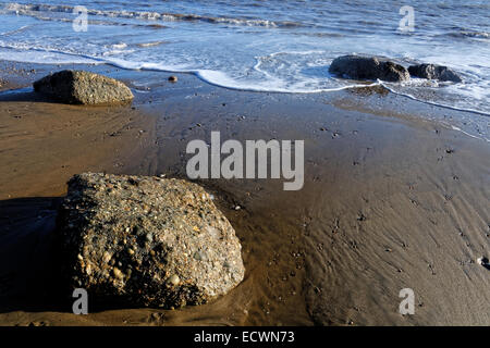 Swirls of seawater erode fallen rocks on the beach of Sandown Bay, Isle of Wight Stock Photo