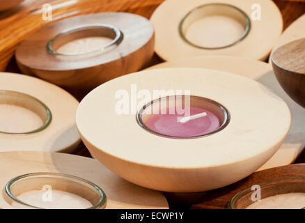 Handmade candles inside wooden candle holder Stock Photo