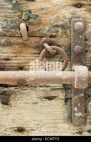 an antique iron latch on an old wooden door Stock Photo