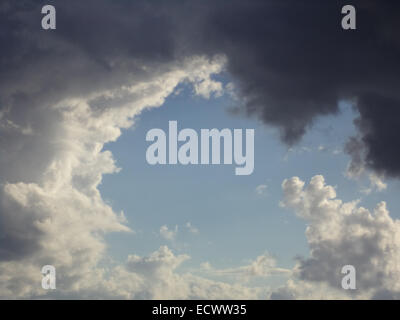 Hole of blue sky in the dark clouds Stock Photo
