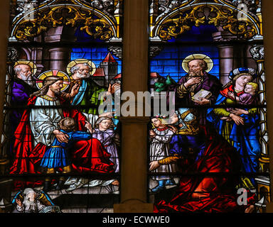 BURGOS, SPAIN - AUGUST 13, 2014: Stained glass window depicting Jesus and children in the cathedral of Burgos, Castille, Spain. Stock Photo