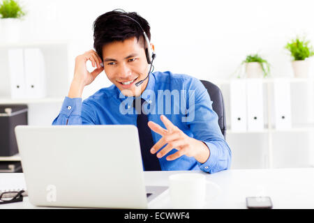smiling businessman wearing a headset at the office Stock Photo