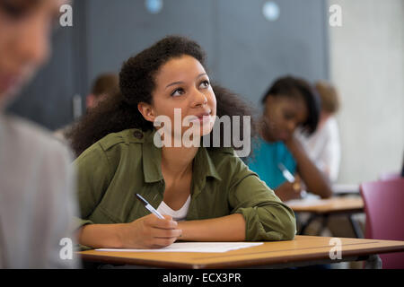University student looking up during exam Stock Photo