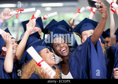 Students taking selfie after graduation ceremony Stock Photo