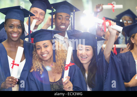 Portrait of university students standing in corridor after graduation ceremony Stock Photo