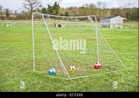 Football goal with colorful balls in it Stock Photo