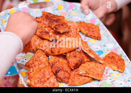 Pizza being served on a tray at a children's party Stock Photo