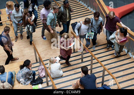 Elevated view of university students walking up and down stairs Stock Photo