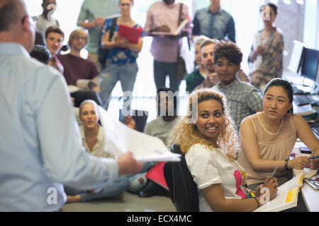 Group of students listening to teacher during lecture Stock Photo