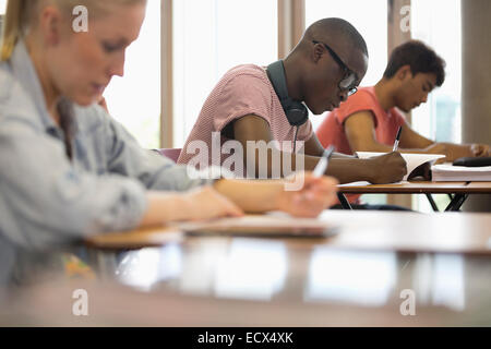 View of students sitting at desks during test in classroom Stock Photo