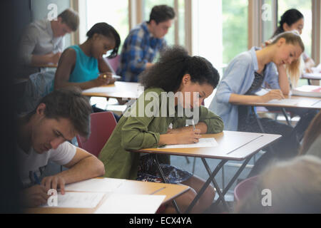 View of students sitting at desks during test in classroom Stock Photo