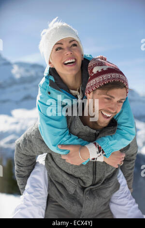Couple playing piggyback ride in park Stock Photo - Alamy