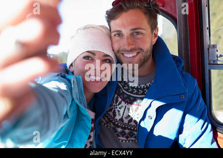 Couple talking selfie in ski lift Stock Photo