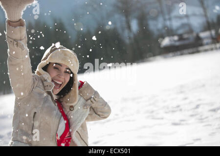 Portrait of exuberant woman in snow Stock Photo