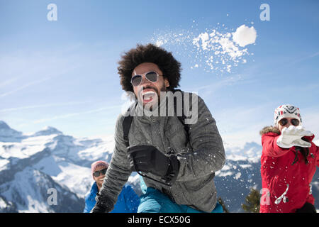 Friends enjoying snowball fight Stock Photo