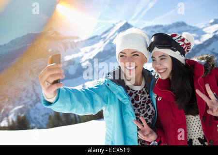 Friends taking selfie in snow Stock Photo