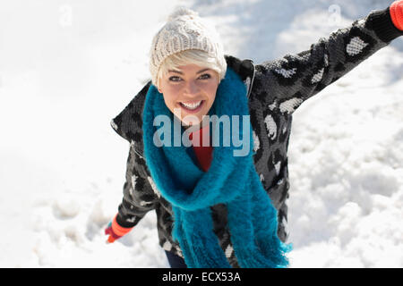 Portrait of smiling woman in snow Stock Photo