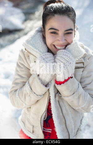 Portrait of smiling woman in snow Stock Photo