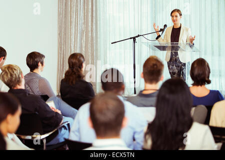 Businesswoman giving presentation in conference room Stock Photo
