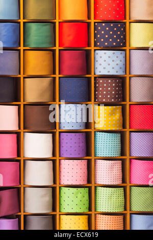 Colorful noname generic ties on display in a wooden shelf Stock Photo
