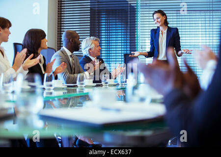 Business people meeting in conference room, woman standing giving speech Stock Photo