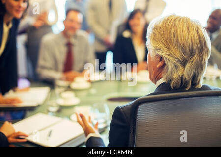 Rear view of mature businessman during business meeting Stock Photo