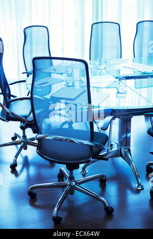 Empty conference room with documents and glasses of water on table Stock Photo